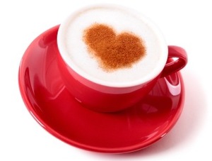 Red coffee cup with heart shape chocolate dusting